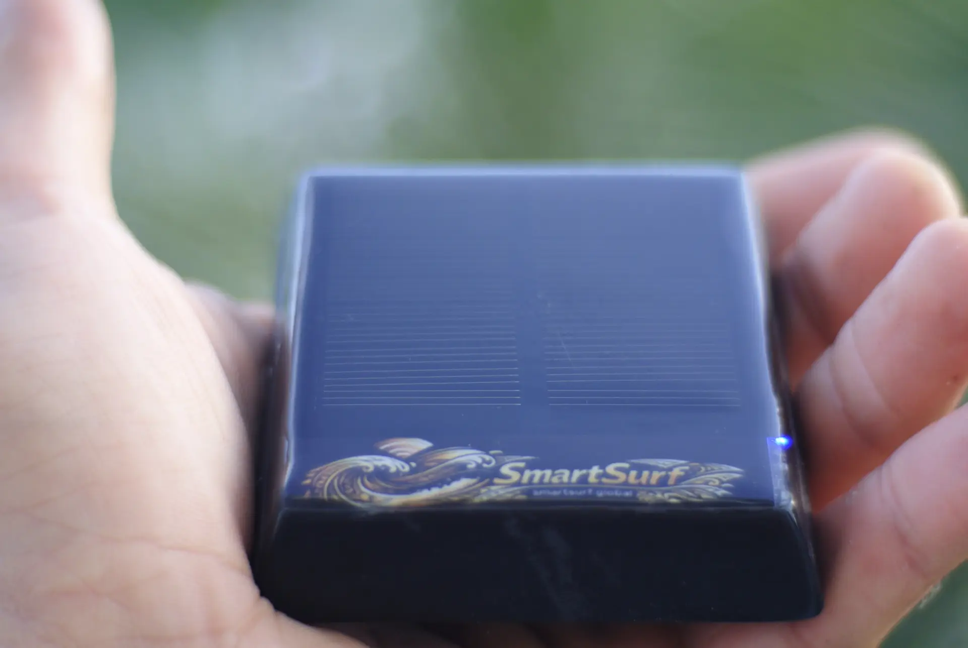 Black SmartSurf tracker in hand